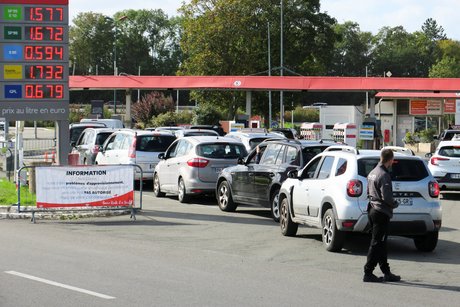 Motorists queue at the petrol pumps of the Auchan service station
