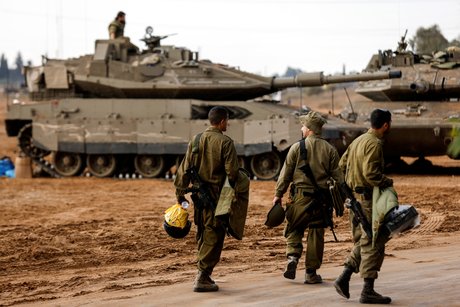 Des soldats israeliens passent devant des chars pres de la frontiere avec gaza