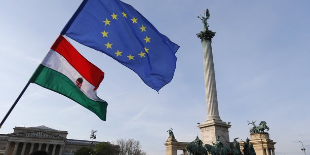 People wave hungarian and european union flags as they protest in heroes’ square against a new law that would undermine central european university in budapest[reuters.com]
