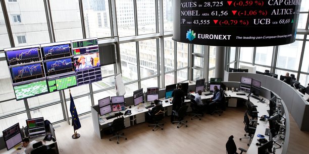 Traders work at their desks in a trading room at the stock market operator euronext headquarters in la defense business and financial district in courbevoie near paris[reuters.com]