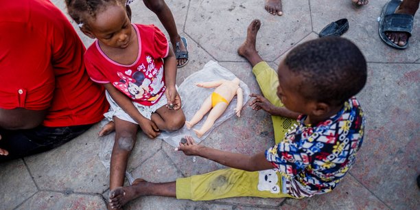 Des enfants jouent avec une poupee cassee sur la place hugo chavez a port-au-prince, haiti[reuters.com]