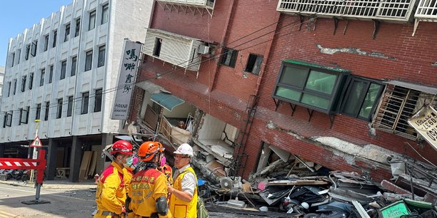 Des pompiers pres d'un batiment s'etant effondre a la suite du tremblement de terre, a taiwan[reuters.com]