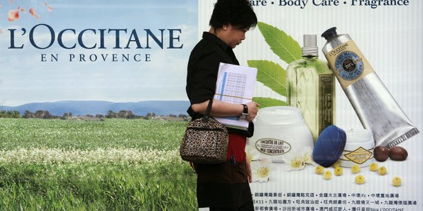 Une femme passe devant une publicite de l'occitane a hong kong. /photo prise le 19 avril 2010/reuters/bobby yip[reuters.com]