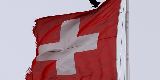 Un oiseau se pose sur un drapeau national suisse a zurich[reuters.com]