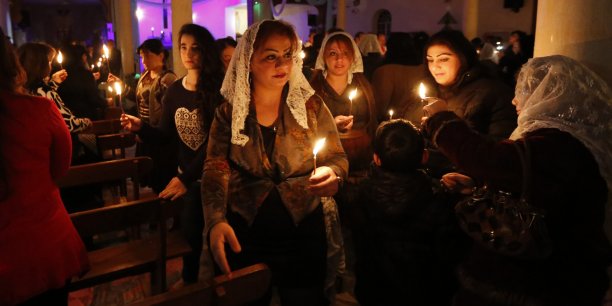 Iraqi christians pray during a mass on christmas eve at sacred heart catholic church in baghdad[reuters.com]