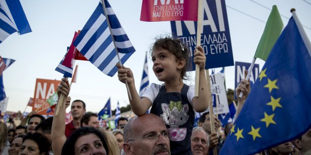 A 'yes' supporter wave greek flags during a pro-euro rally at the panathenean stadium in athens[reuters.com]