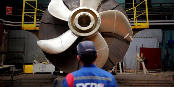 An employee looks at the propeller of a scorpene submarine at the industrial site of the naval defence company and shipbuilder dcns in la montagne[reuters.com]