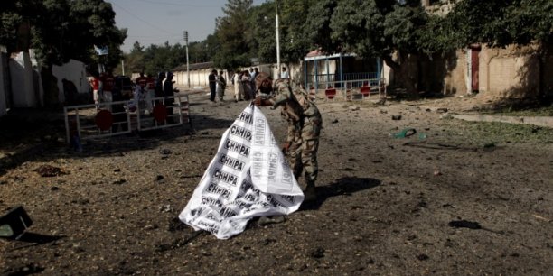A soldier covers a body after a blast in quetta[reuters.com]