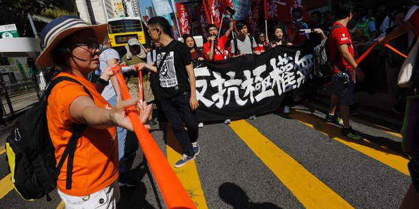 Manifestation a hong kong apres la condamnation de trois chefs de file de la contestation[reuters.com]