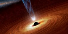 Dans cette illustration fournie par la Nasa, le trou noir supermassif au centre est entouré par ce qu'on appelle un disque d'accrétion fait de matière s'écoulant vers le trou noir, lequel expulse un jet particules énergétiques dû à la rotation du système.