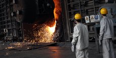 Employés devant un four de l'entreprise sidérurgique Huaxi Iron and Steel Compagny, à Huaxi, dans la province de Jiangsu.
