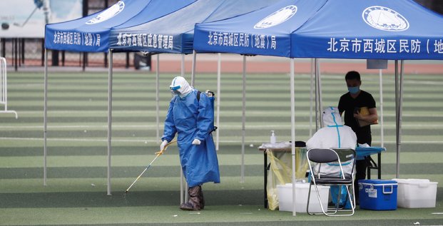 Pékin, Chine, coronavirus : un homme en tenue de protection diffuse du désinfectant au Guangan Sport Center