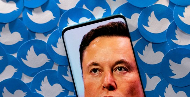 File photo: illustration shows elon musk image on smartphone and printed twitter logos