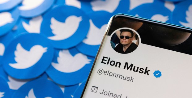 Le profil twitter d'elon musk sur un smartphone place sur des logos twitter