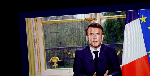 Le president francais emmanuel macron apparait sur un ecran, alors qu'il s'exprime lors d'un discours