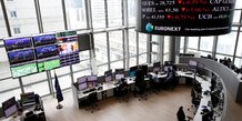 Traders work at their desks in a trading room at the stock market operator euronext headquarters in la defense business and financial district in courbevoie near paris